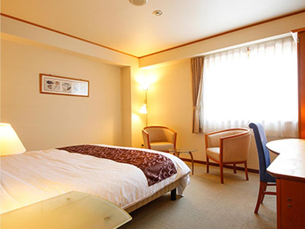 Postel nebo postele na pokoji v ubytování Hotel BELLMARE ホテルベルマーレ