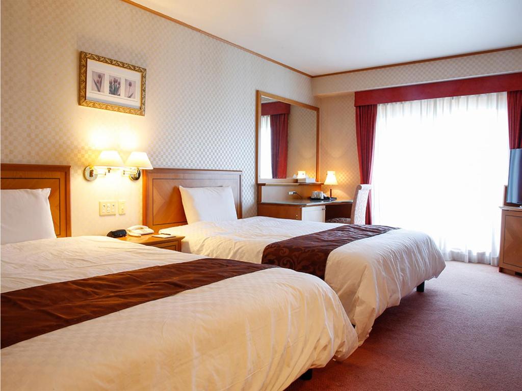 Postel nebo postele na pokoji v ubytování Hotel BELLMARE ホテルベルマーレ