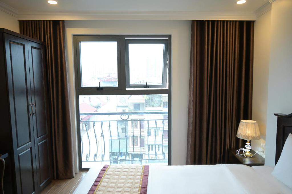Postel nebo postele na pokoji v ubytování Mercy Hotel