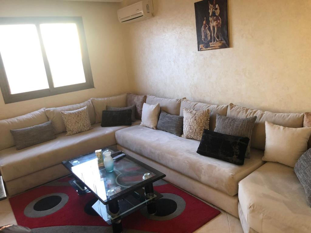 a living room with a couch and a table at appartement a Marrakech in Marrakech
