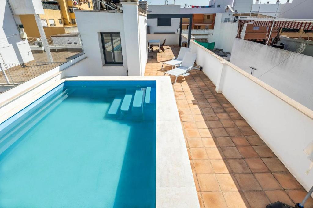 a swimming pool on the roof of a house at Slow Sevilla suite - two-bedroom apartment with private pool in Seville