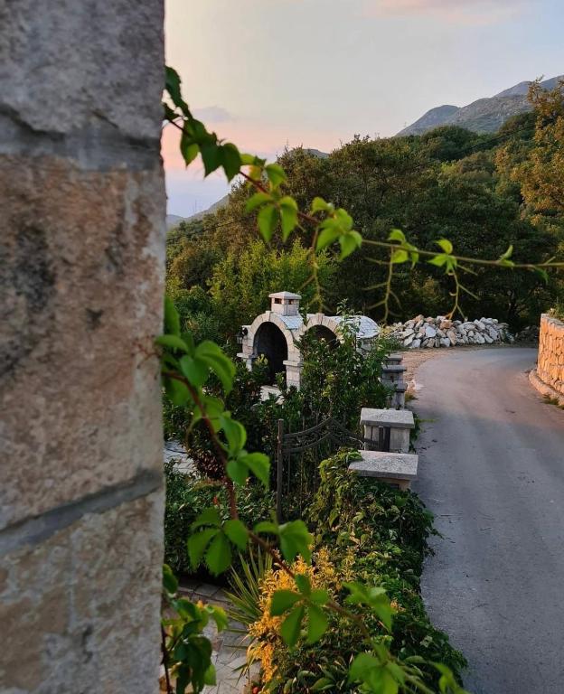 a road with a building on the side of a hill at Apartmani Gazivode in Budva