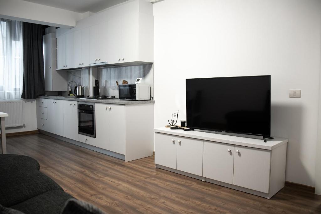 a living room with a flat screen tv on a white cabinet at Nordic Residence 1 in Suceava