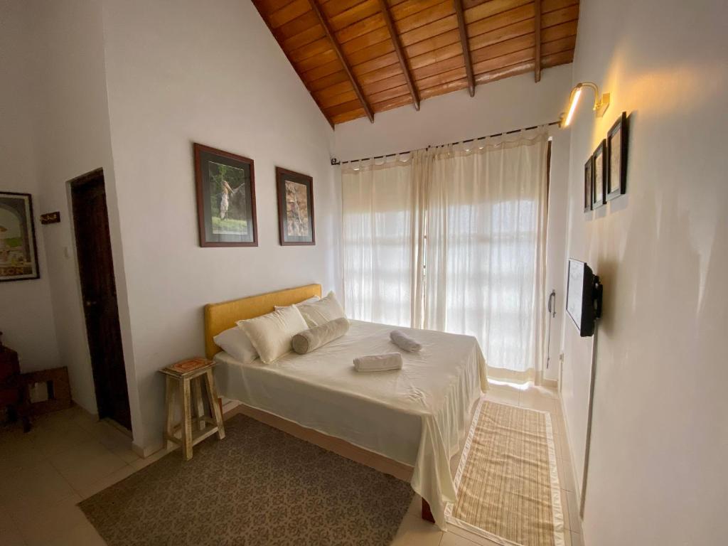 a small bedroom with a bed and a window at Misty Hills Villa - Kandy in Kandy