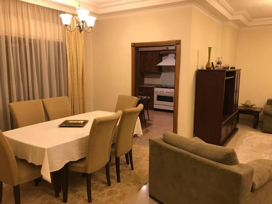 a dining room with a table and chairs at 2 Bed Room Apparment in Amman - Der Ghbar in Amman