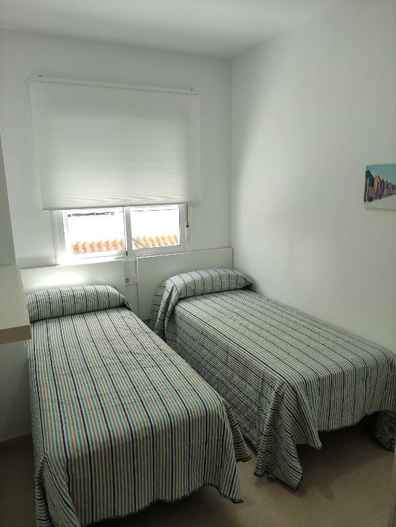 Posteľ alebo postele v izbe v ubytovaní Apartamentos Montedunas