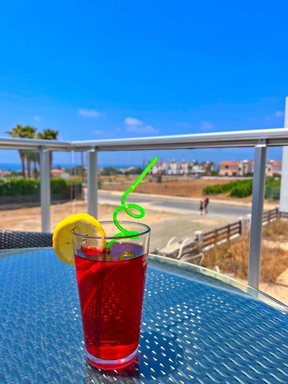 a drink on a table with a lemon slice at 3 Bedroom Coral Bay Beach Seaview Villa I Private Pool in Peyia
