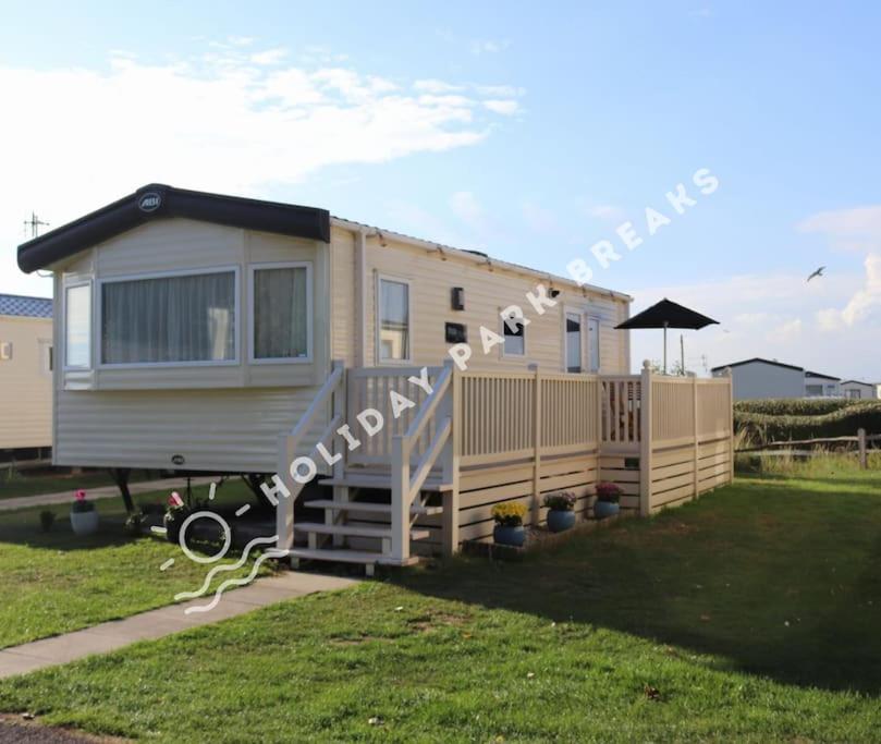 a mobile home is parked in a yard at Homely 2 bed @ Seal Bay Resort in Selsey