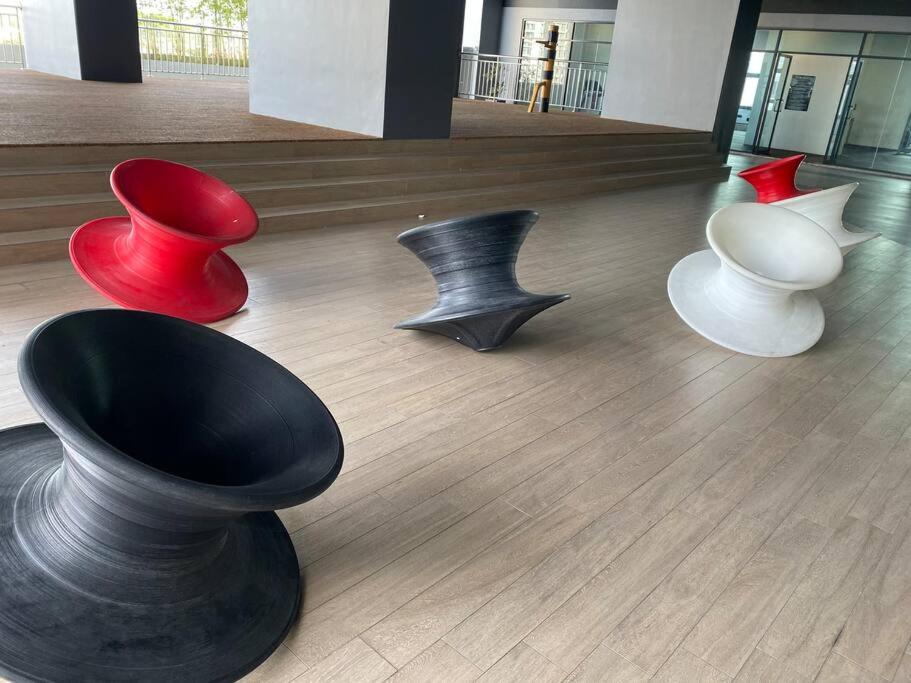 a group of chairs sitting on a wooden floor at Simfoni Tower 3R2B 8pax @C180@Chr Trader Square in Seri Kembangan
