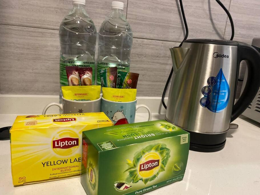 a counter with two bottles of water and a blender at Simfoni Tower 3R2B 8pax @C180@Chr Trader Square in Seri Kembangan