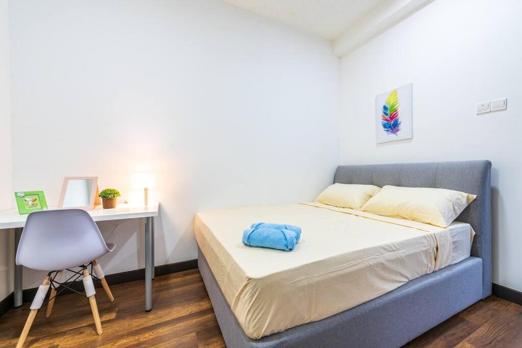 a bedroom with a bed and a desk and a chair at Simfoni Tower 3R2B 8pax @C180@Chr Trader Square in Seri Kembangan