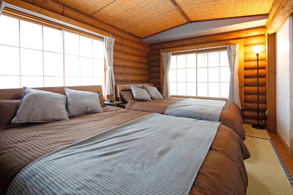 Postel nebo postele na pokoji v ubytování The LODGE ABASHIRI