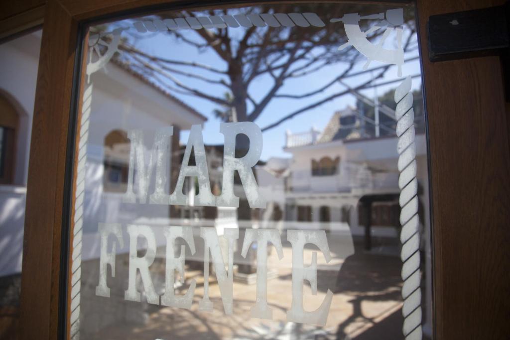 a glass window with the words real estate written on it at Hostal Mar de Frente in Los Caños de Meca