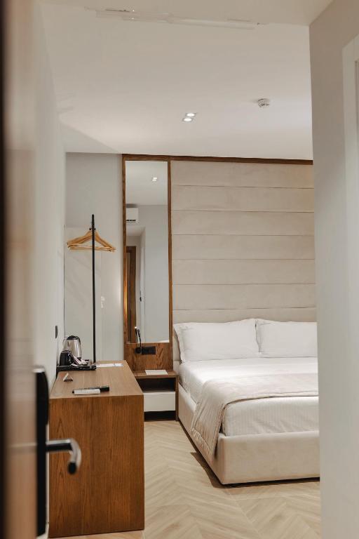 a bedroom with a bed and a phone on a table at Duka's Hotel in Ksamil