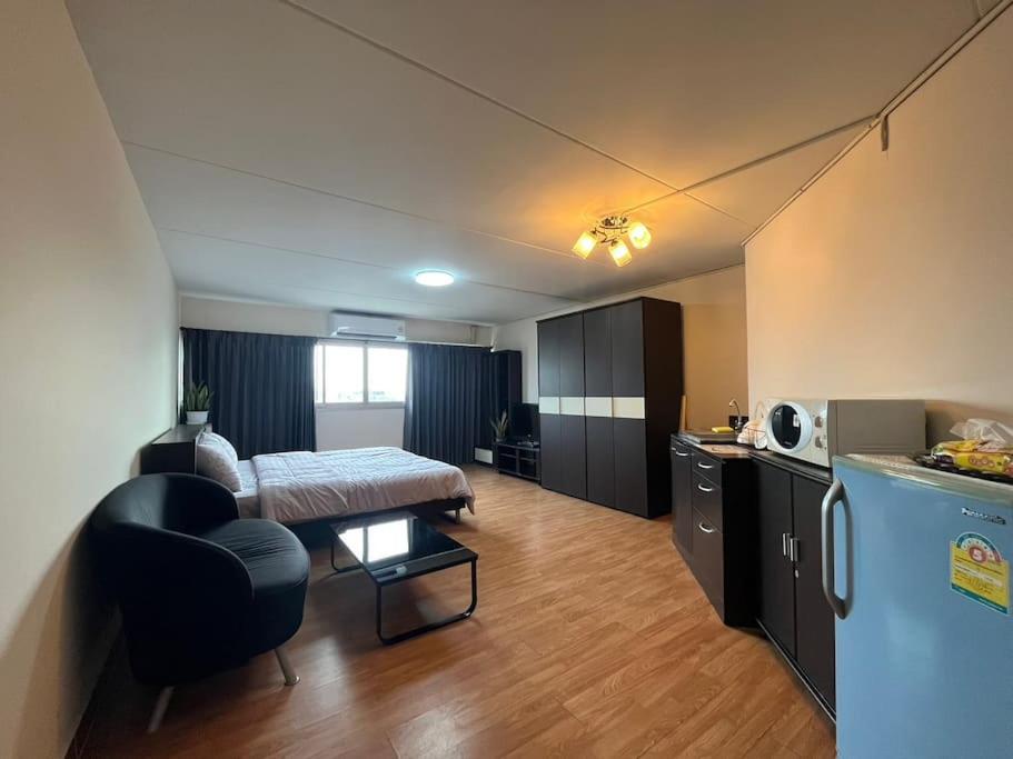 a room with a bed and a kitchen with a table at T12 Popular Condo By : hunnity in Ban Bang Phang