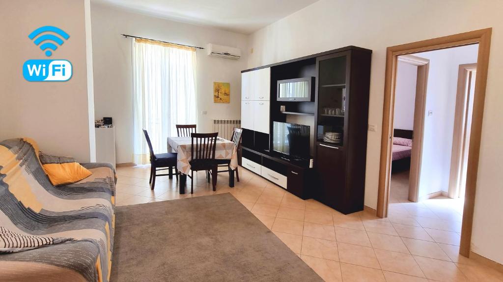 a living room with a couch and a dining room at Casa del Teatro in Brindisi
