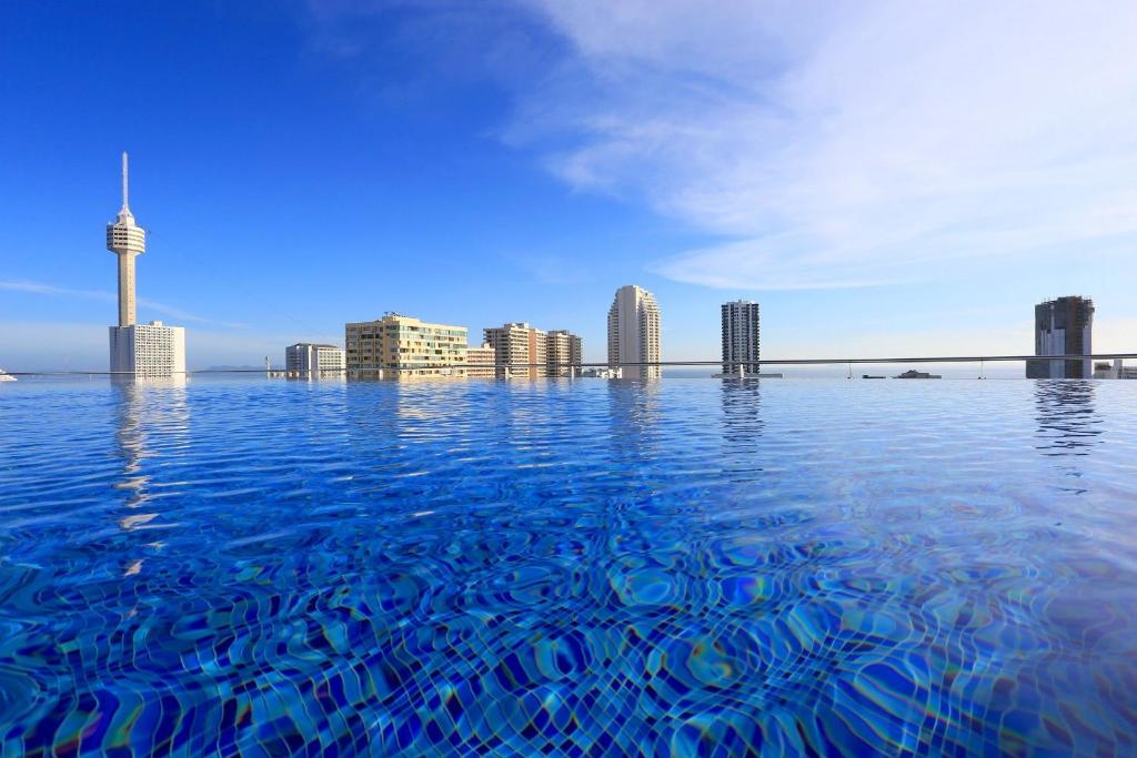 a view of the city from the infinity pool at Sirin Exclusive Hotel and Residence in Pattaya South