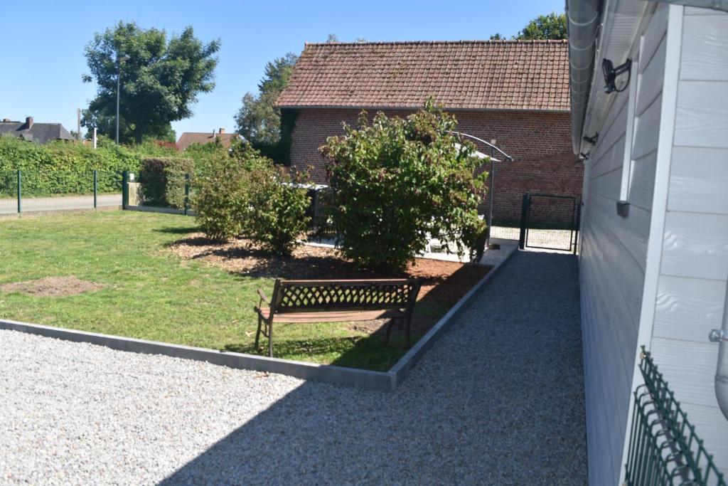 un banc assis dans une cour à côté d'un bâtiment dans l'établissement Clos Marie-Louise, à Offranville