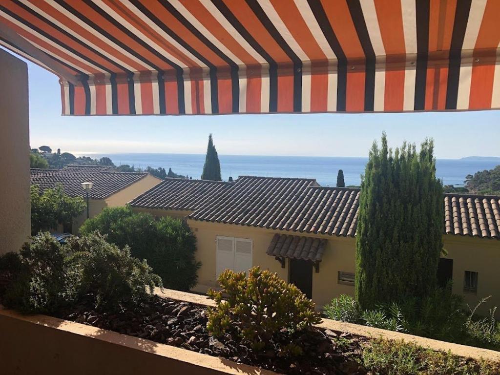 a view from a balcony of a house with an umbrella at Studio Le Lavandou, 1 pièce, 2 personnes - FR-1-308-183 in Le Lavandou