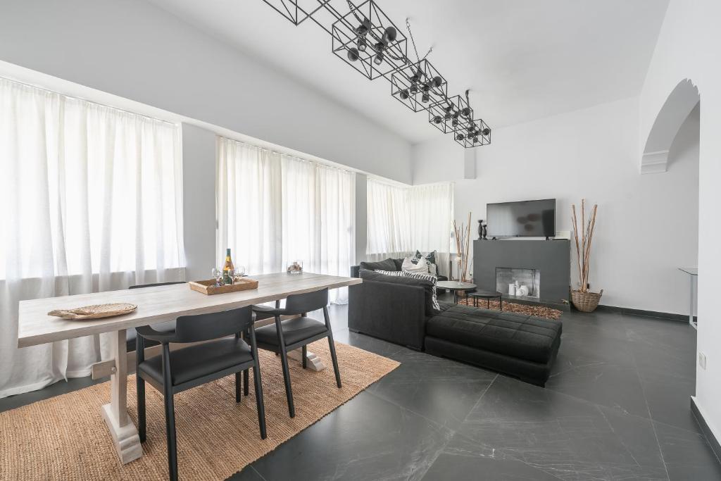 a living room with a table and a couch at Garden Villa Glyfada in Athens