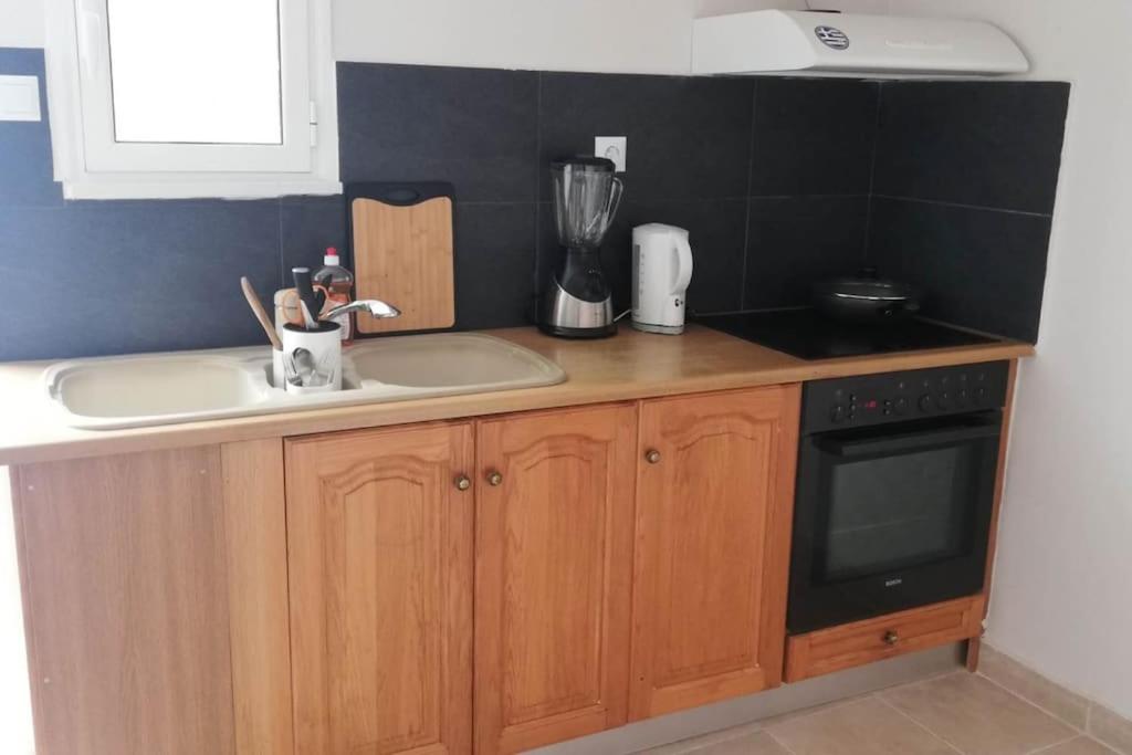 a kitchen with a sink and a counter top at Family Inn in Athens