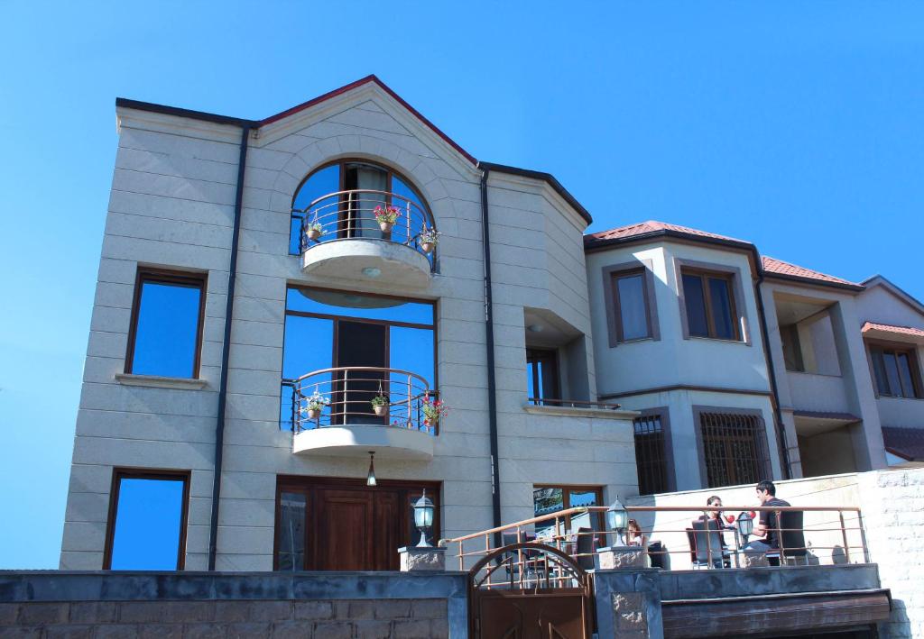 a large house with people sitting on a balcony at Art Hotel in Yerevan