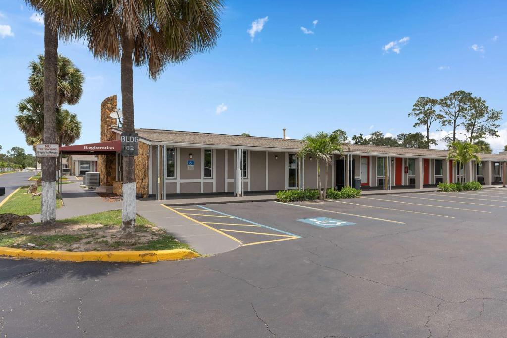 an empty parking lot in front of a motel at Super 8 by Wyndham Kissimmee-Orlando in Orlando