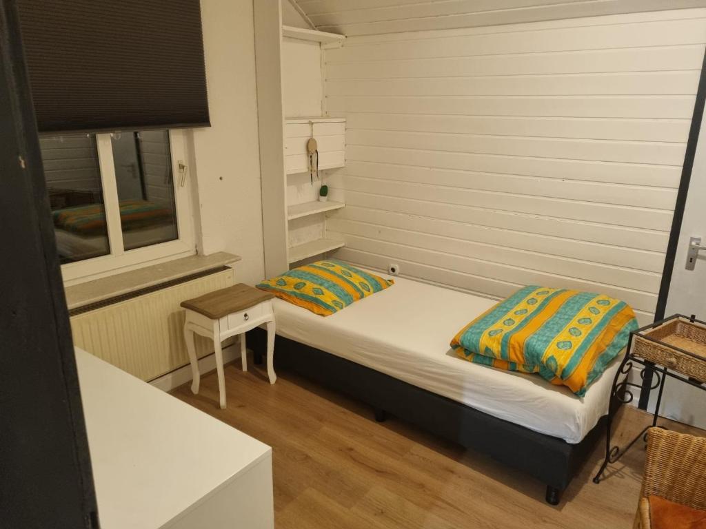 a small bedroom with two beds in a room at Appartement in Nijmegen Kranenburg in Kranenburg