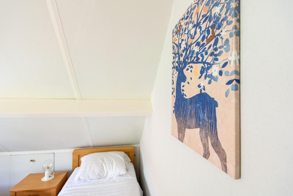 Postel nebo postele na pokoji v ubytování LUXE vakantiehuis voor 6P voorzien van alle gemakken @Veluwe
