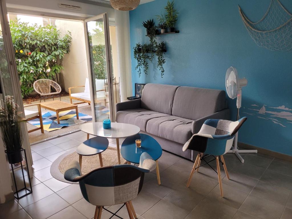 sala de estar con sofá, mesa y sillas en Appartement Centre de La Teste, en La Teste-de-Buch