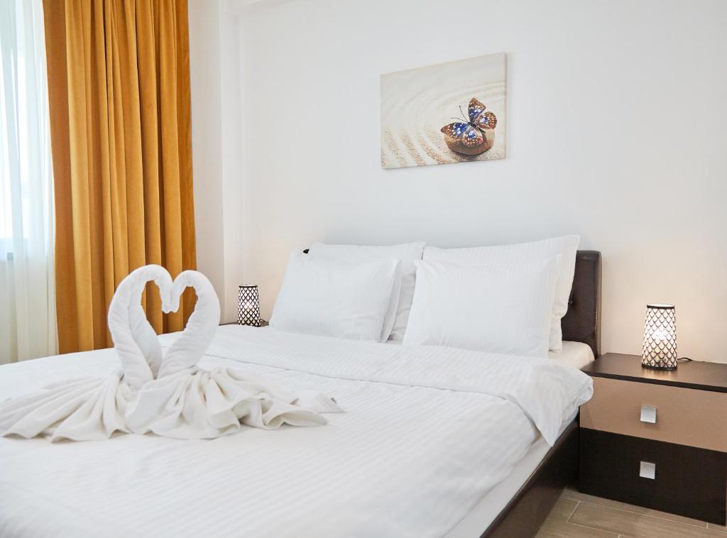 Кровать или кровати в номере Excelsior Apartaments Mamaia Nord