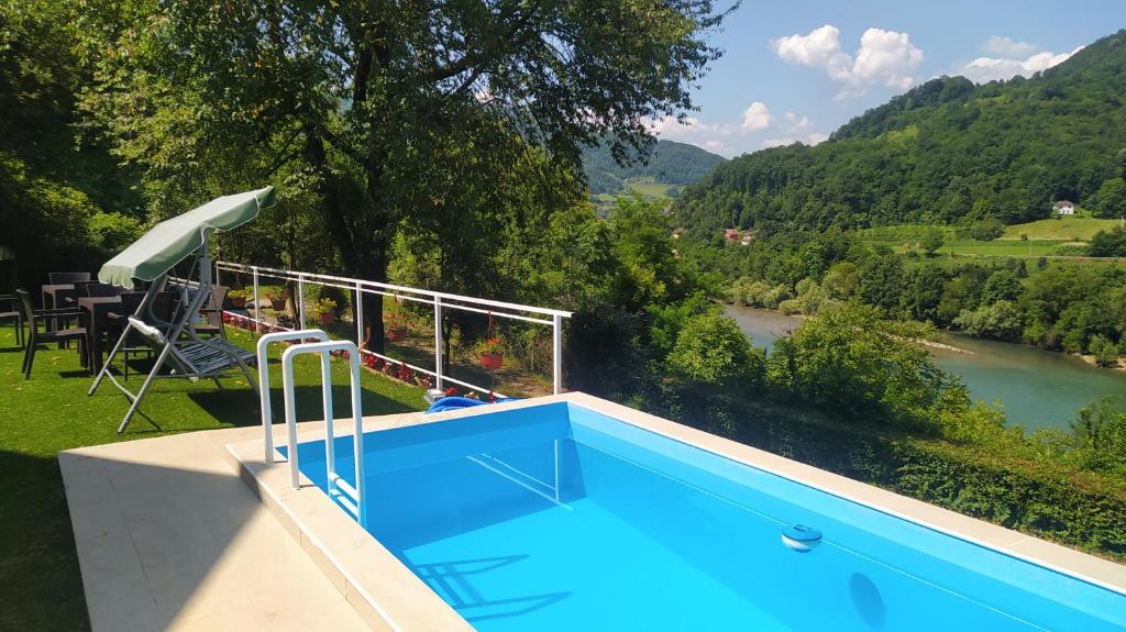 a swimming pool with a view of a river at Apartmani Zora-Vuković in Bajina Bašta