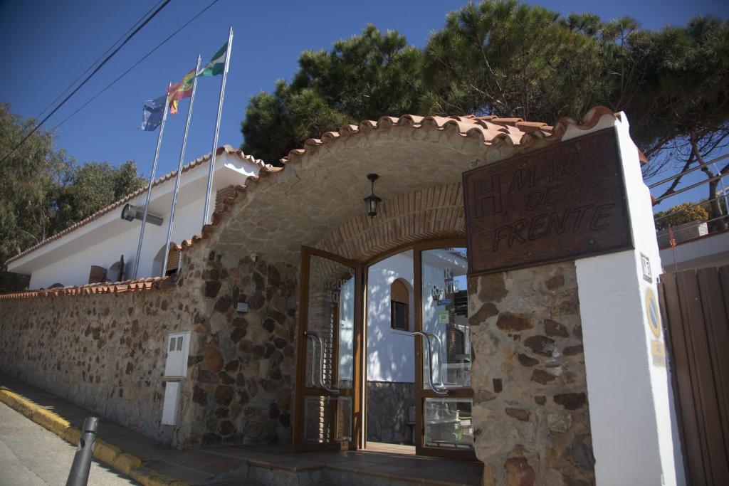 a building with a sign that reads house of refuge at Hostal Mar de Frente in Los Caños de Meca