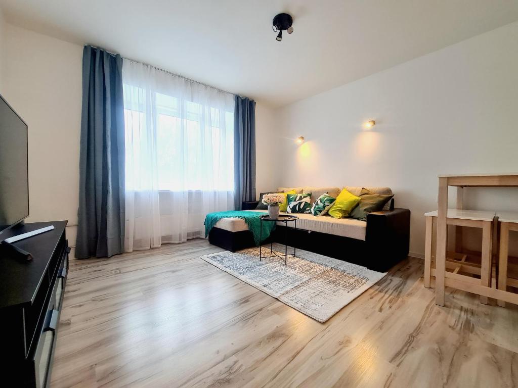 a living room with a couch and a table at Tammsaare 28 Beach Apartment in Pärnu