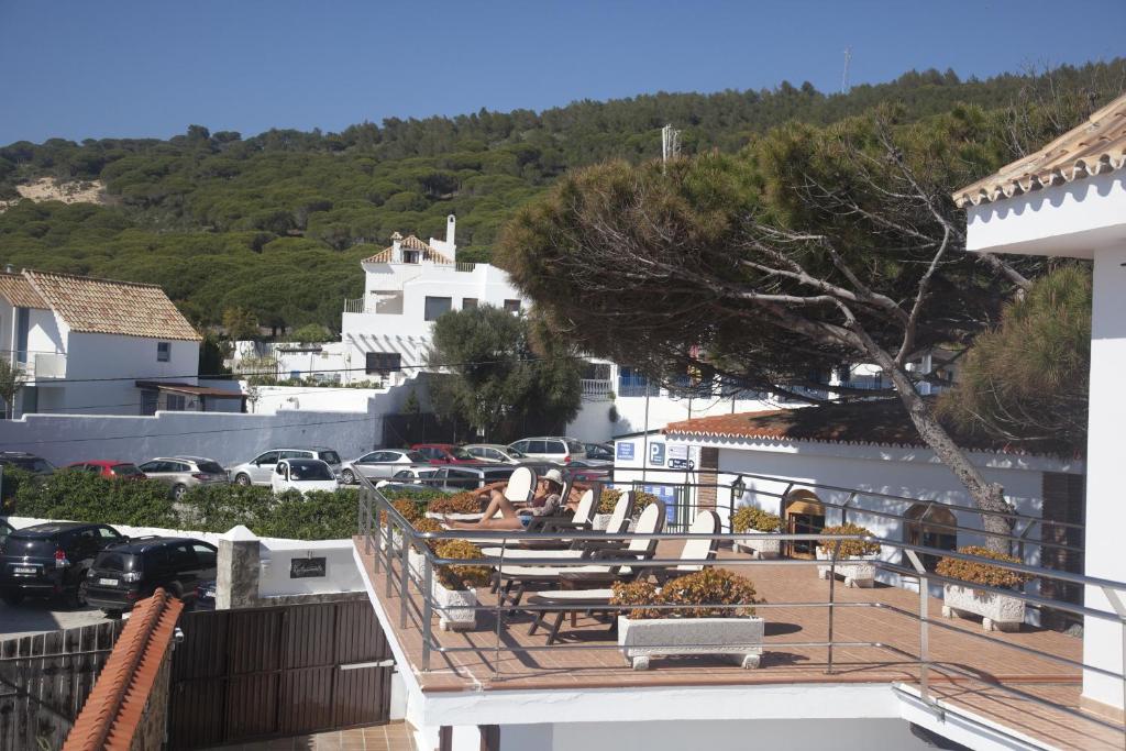 a balcony of a hotel with tables and chairs at Hostal Mar de Frente in Los Caños de Meca