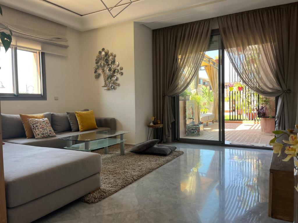 uma sala de estar com um sofá e uma mesa em Marrakech M Avenue CR 7 appart terrasse em Marrakech