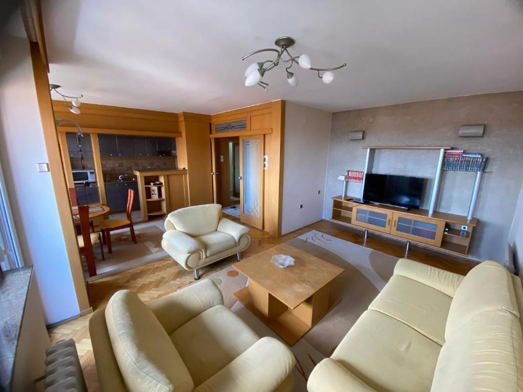 a living room with a couch and a table at Family Apartment in City Centre in Bitola