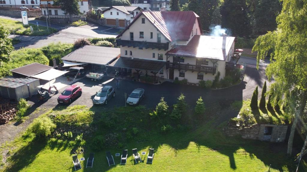 an aerial view of a house with cars parked in a yard at Pension Aura Špičák, některé pokoje se saunou in Železná Ruda