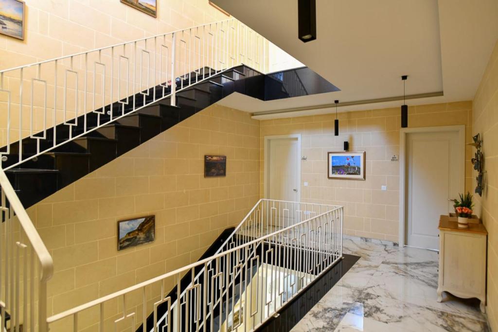 a hallway with a staircase in a building at Azure W B&B in San Lawrenz