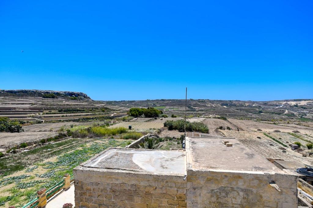 an aerial view of an old building in a field at Azure W B&B in San Lawrenz