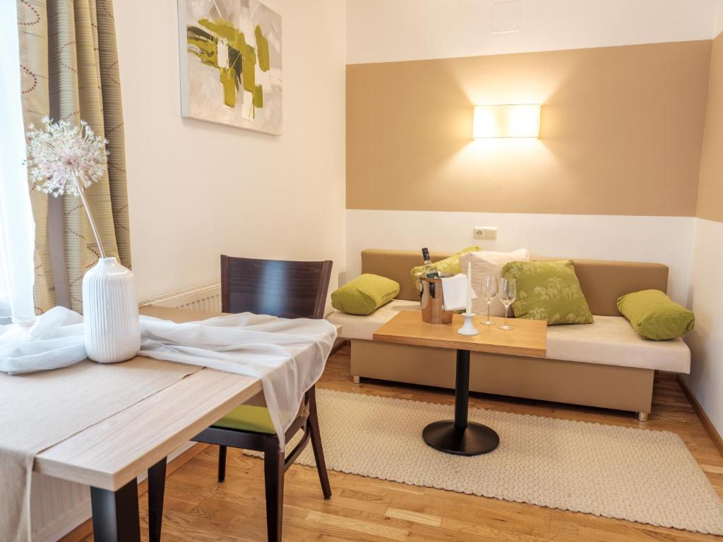 a living room with a table and a couch at Ferienwohnung im Naturpark Almenland in Fladnitz an der Teichalm