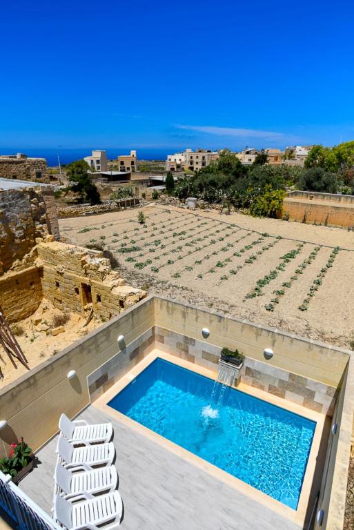 a swimming pool on top of a building at Azure W B&B in San Lawrenz