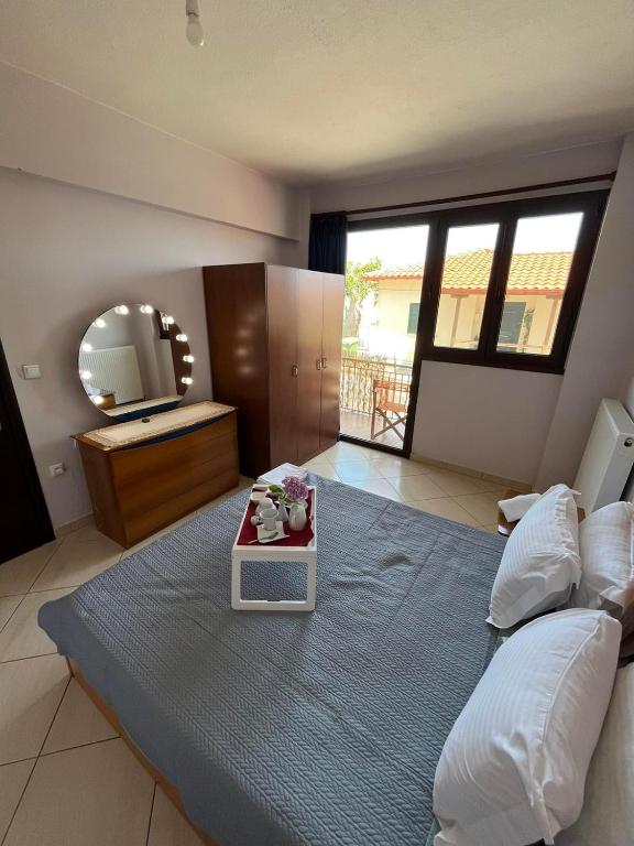 a bedroom with a large bed with a mirror at HIPPOCAMPUS APARTMENT in Stratoni