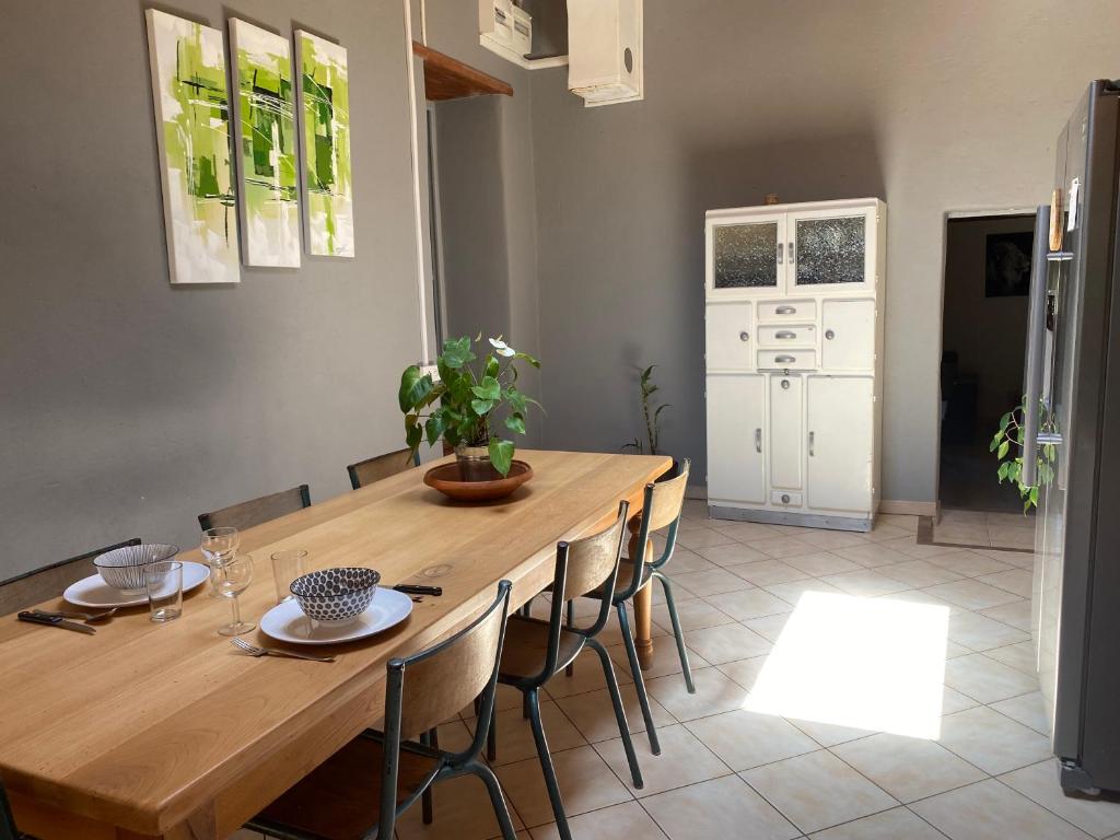 une salle à manger avec une table et des chaises en bois dans l'établissement Appartement Amarante, à Puy-Saint-Martin