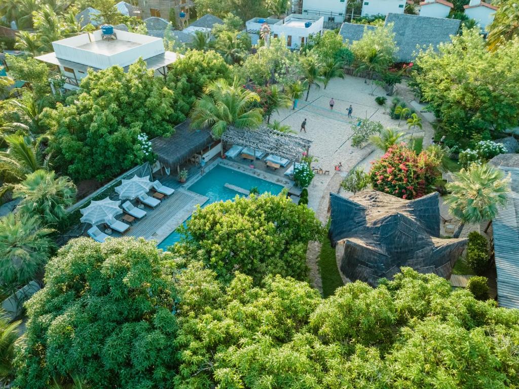 an aerial view of a resort with a pool and trees at La Cozinha Bungalow in Barra Grande