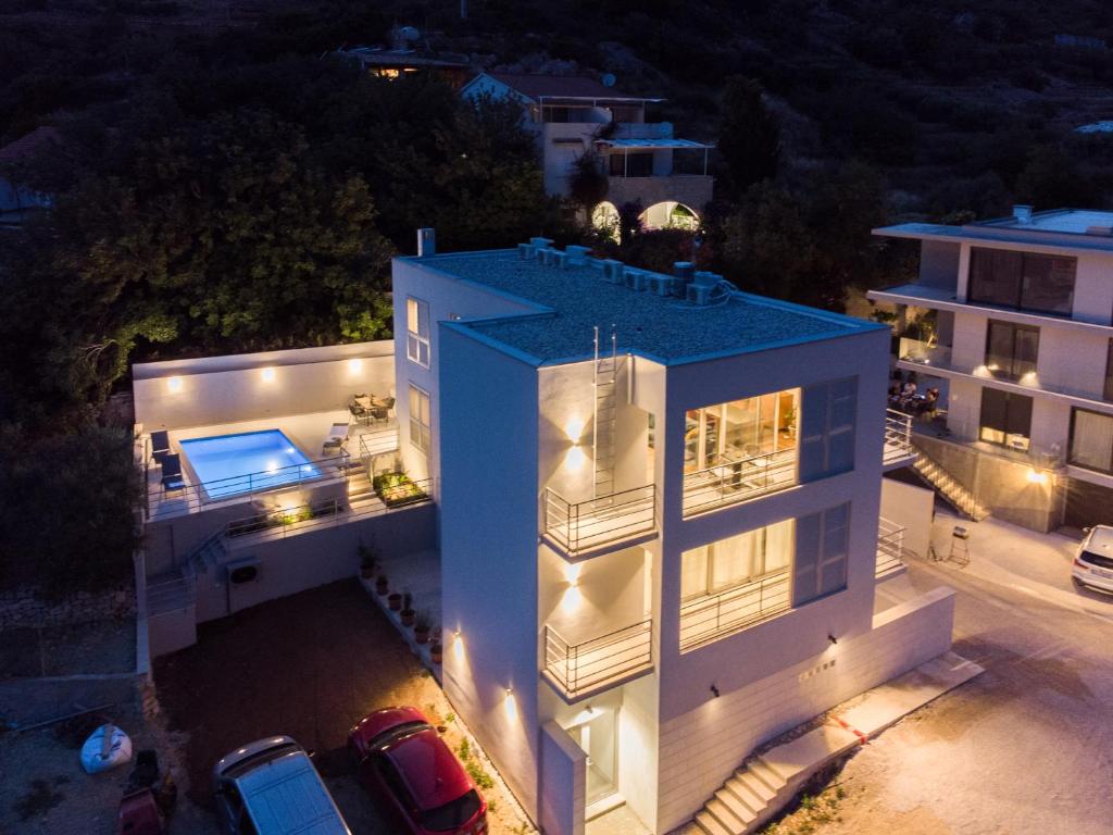 an aerial view of a house at night at Seaside Elegance Suites in Komiža