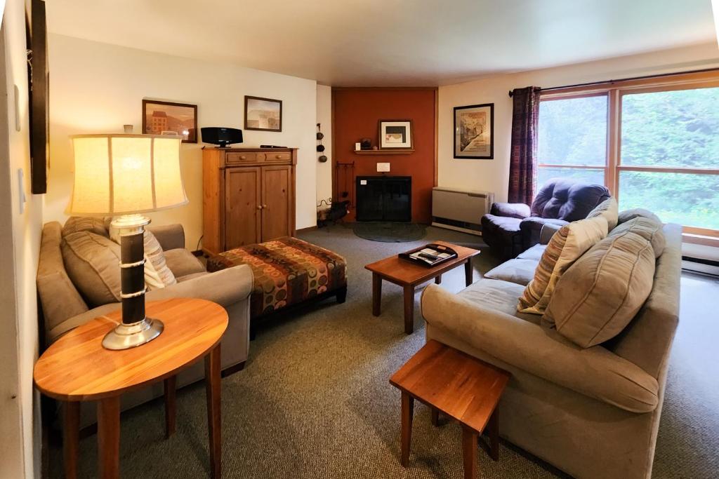 a living room with two couches and a table at Trail Creek 20 in Killington