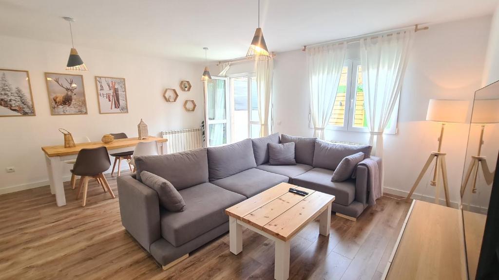a living room with a couch and a table at VUT Sierra Pambley in Villablino