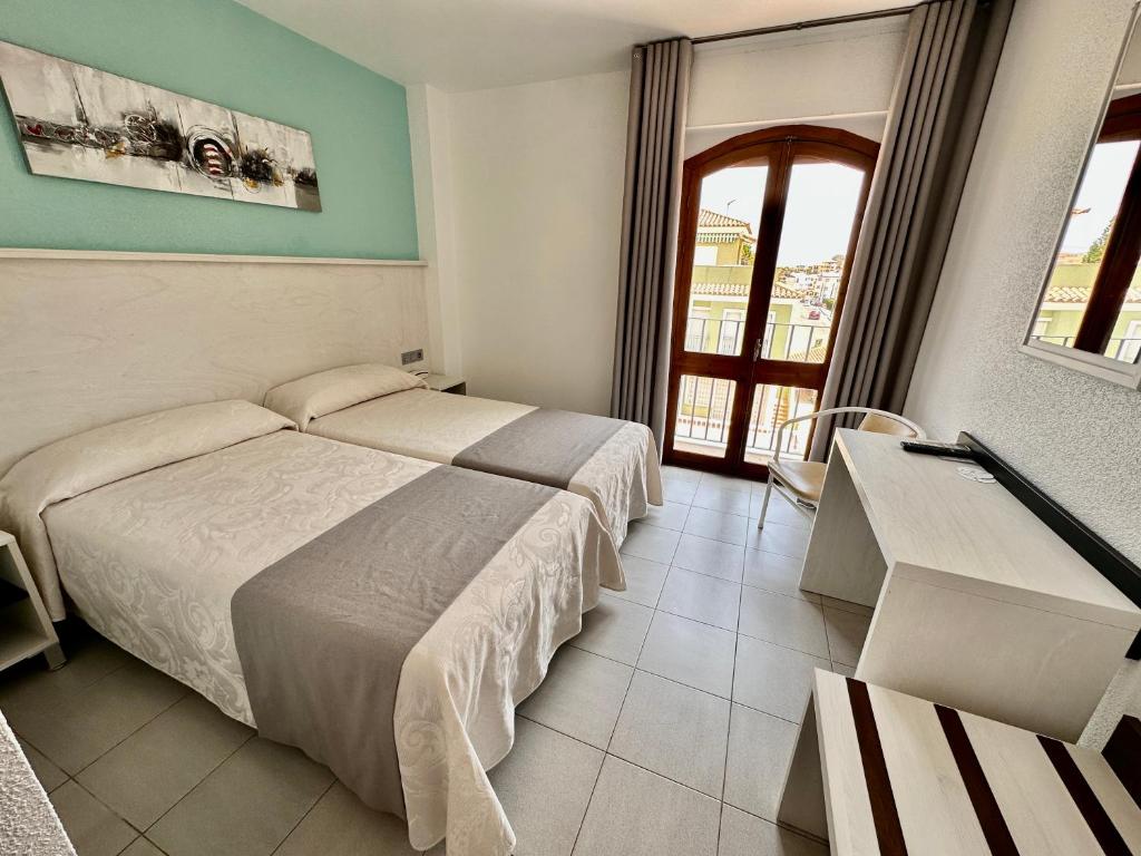 Postel nebo postele na pokoji v ubytování Hotel El Paraíso