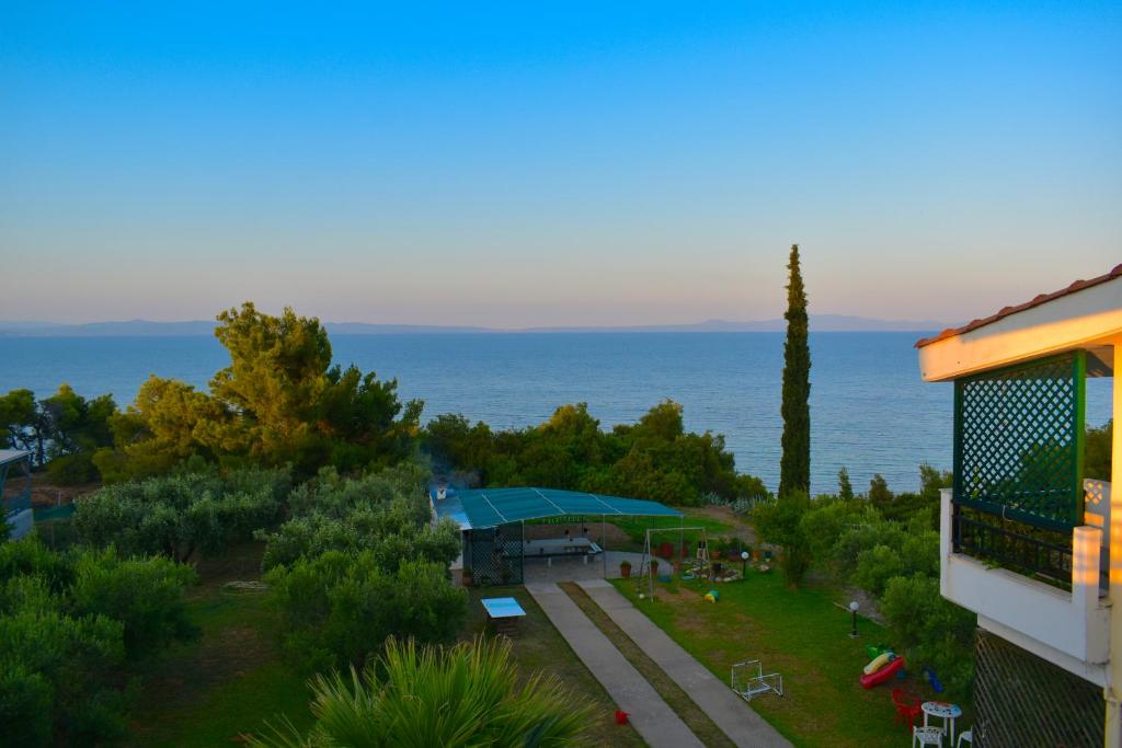 a view of a building with the ocean in the background at Elegant Maisonettes Elena in Nea Potidaea